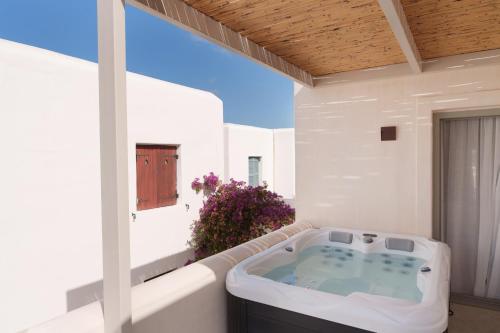 a jacuzzi tub sitting on a balcony at Salt Suites Paros in Naousa