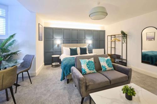 a hotel room with a bed and a couch and a table at Host & Stay - The Langley Hotel in Whitby