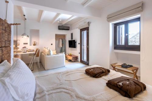 a bedroom with a large bed and a living room at stema suite 1 in Tripiti