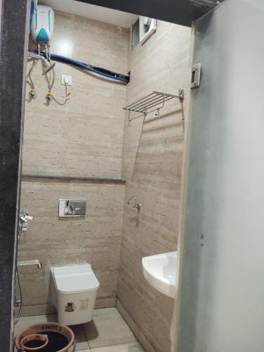 a small bathroom with a toilet and a sink at Hotel Casa Del Sol in Raipur