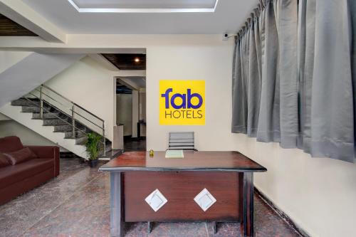 an office with a desk and a sign on a wall at FabHotel Heaven 75 in Hyderabad