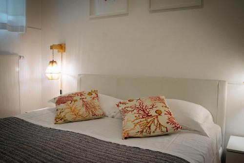 a bedroom with a bed with two pillows on it at Lake House in Nago-Torbole