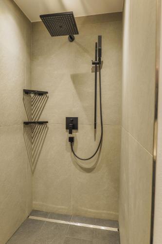 a shower with a shower head in a bathroom at Appartement Aichner in Mittersill