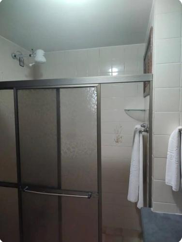 a shower with a glass door in a bathroom at Portobello in Porto Seguro