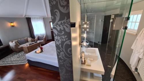 a bathroom with a bed and a shower and a sink at Quinta do Cabo Guesthouse in Sintra