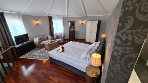 a bedroom with a bed and a living room at Quinta do Cabo Guesthouse in Sintra