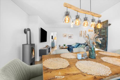 a living room with a table and a fireplace at Strandgeflüster in Olpenitz