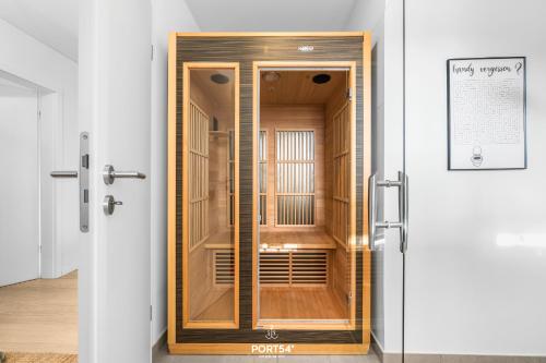 an open door of a wooden cabinet in a room at Strandgeflüster in Olpenitz