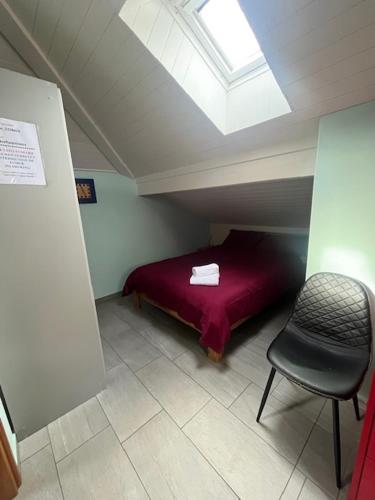 a bedroom with a bed and a chair in a attic at Casa Pesa - Olivone in Olivone