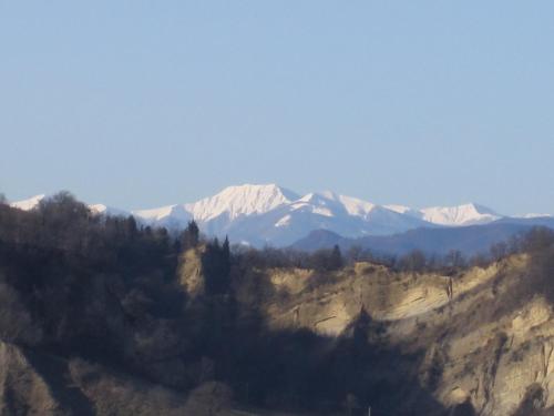 a mountain with snow capped mountains in the distance at Borgo Pizzicarè in Vado