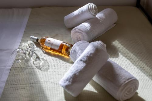 a group of rolled up toilet paper and a bottle at Seaside Stone Retreat in Salamina