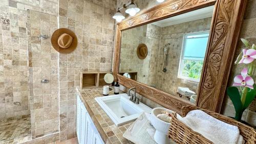 a bathroom with a sink and a large mirror at 8 Bedroom Ocean Front in Eleuthera Double Bay with pool in Savannah Sound