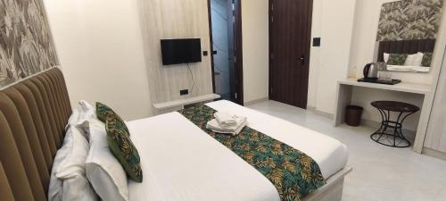 En eller flere senge i et værelse på Hotel La Serene