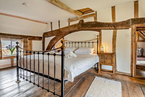 a bedroom with a bed in a room with wooden floors at 3 Bed in Rumburgh oc-c27094 in Rumburgh