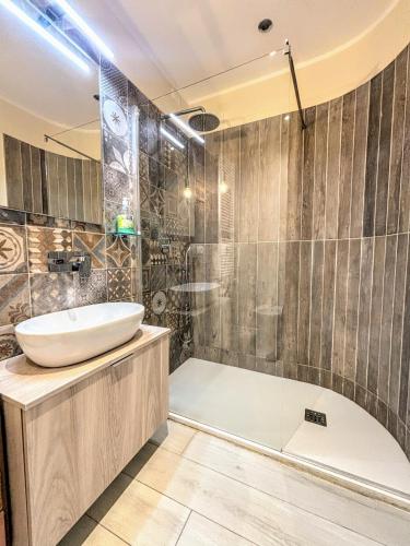 a bathroom with a tub and a sink and a shower at Il Sole in Terrazza - A due Passi dal Mare - Private Garden and Parking in Cinquale