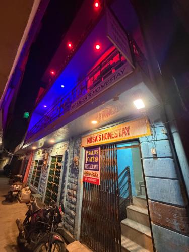 a building with a motorcycle parked in front of it at Musa's Homestay in Jodhpur