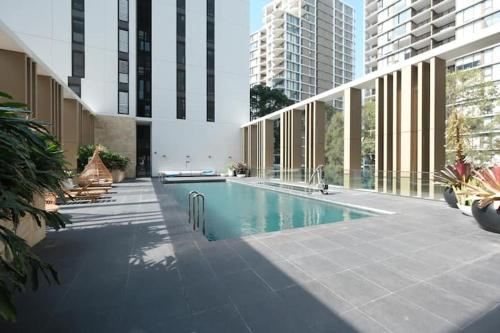 a swimming pool in the middle of a building at Macquarie Park Station,2BR, 4 Beds,Parking,Swimming Pool in Sydney