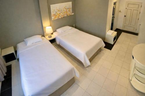 Postel nebo postele na pokoji v ubytování Shalom Center chaweng Samui