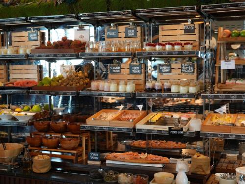 a display case in a store filled with lots of food at VIE Hotel Bangkok - MGallery Collection in Bangkok