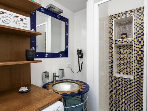 a bathroom with a sink and a mirror at Ficus Home - De Vivo Realty in Sant'Agnello