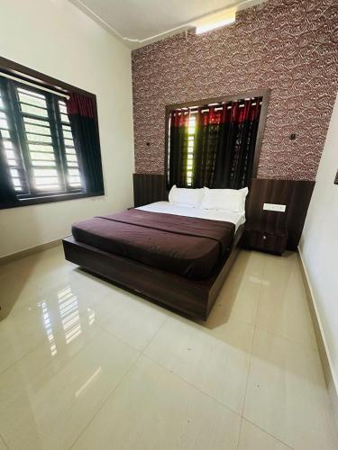 una camera da letto con un letto e un muro di mattoni di Grand Glorious Resort a Padinjarathara