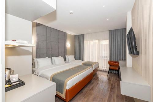 En eller flere senge i et værelse på Tumar Hotel