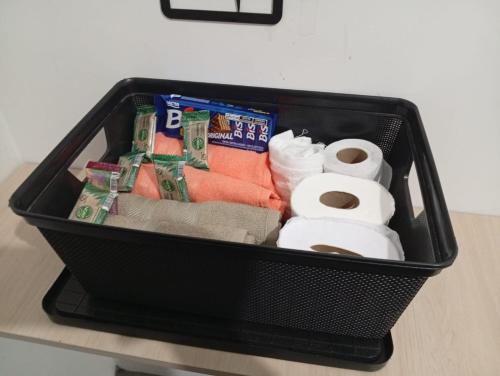 a black basket sitting on a counter with toilet paper at Apartamento Serena in Votorantim