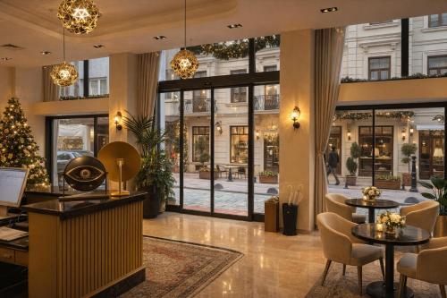 a lobby with a christmas tree and tables and chairs at Mandala Karaköy Hotel in Istanbul