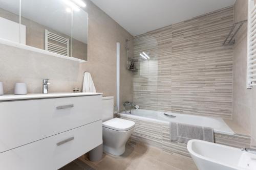 een badkamer met een bad, een toilet en een wastafel bij Casa Miramar Oak 47 in Fuengirola