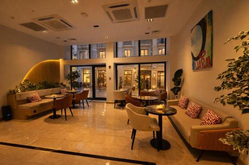 a lobby of a restaurant with tables and chairs at Mandala Karaköy Hotel in Istanbul