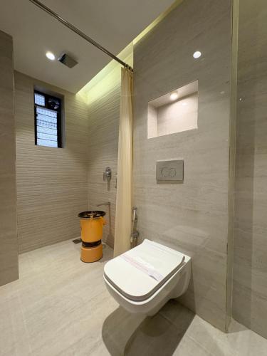 a bathroom with a toilet and a shower at Hotel JK Palace Newly Renovate in Shirdi