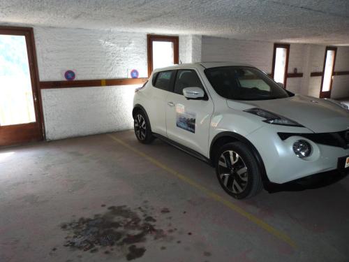a small white car parked in a garage at Ransol - El Tarter in Ransol