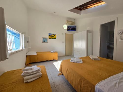 a room with two beds with towels on them at Hotel Marittimo in Rimini