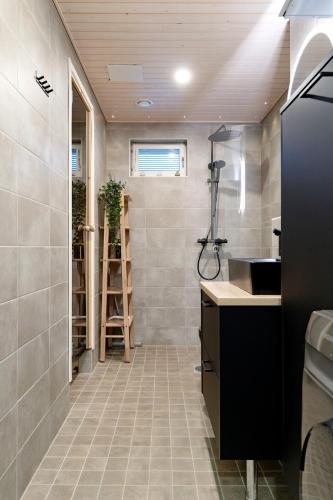 a bathroom with a sink and a shower at Luxury Apartment By Lapland Host in Rovaniemi