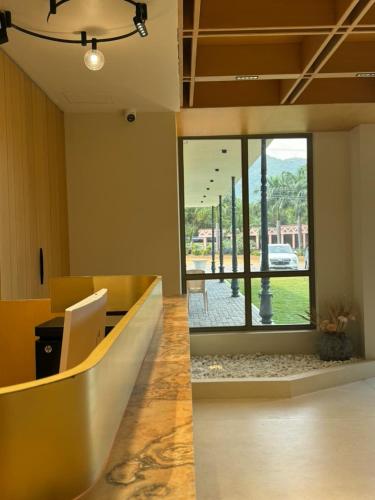 an office with a lobby with a large glass door at Hotel Aarka in Mettuppālaiyam