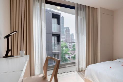 een slaapkamer met een bed en een groot raam bij 2BR2BA BTS Thonglor Rooftop Pool Gym BBQ Low in Bangkok