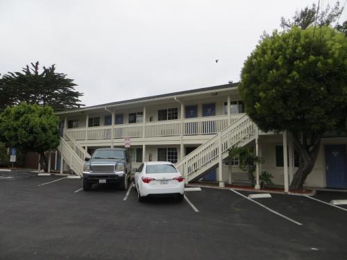 a white car parked in front of a building at Fisherman's Cove Inn in Monterey