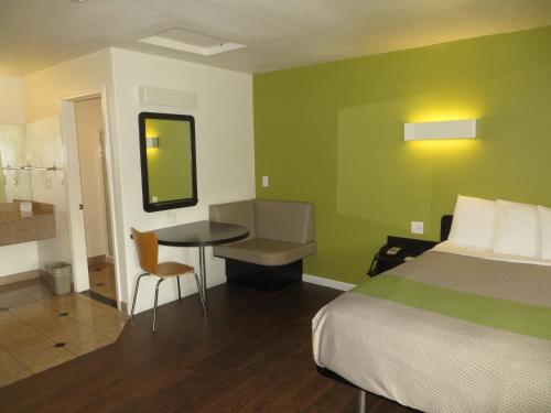 a hotel room with a bed and a table and chair at Fisherman's Cove Inn in Monterey