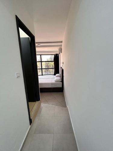 a hallway with a mirror and a bed in a room at Tanger sun studios in Tangier