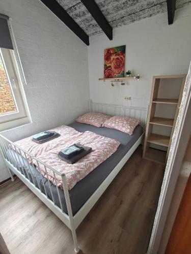 a bedroom with two bunk beds and a shelf at Vakantie Zuid Limburg in Simpelveld