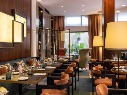 a row of tables and chairs in a restaurant at Hotel Montalembert in Paris