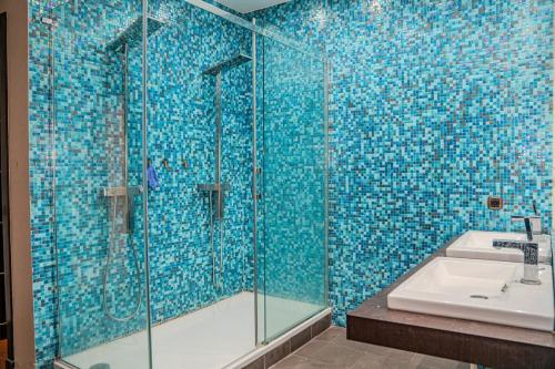 a bathroom with a glass shower and a sink at Marina Agadir Grand Luxury 3 Bedroom Sea view Apartment-familial in Agadir