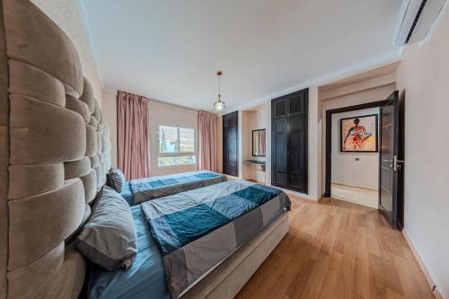 a bedroom with a bed and a large window at Marina Agadir Grand Luxury 3 Bedroom Sea view Apartment-familial in Agadir