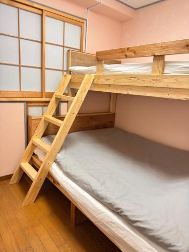 a bunk bed in a room with a bunk bed frame at Sunflower Hotel 703, Osaka, Namba & Shinsaibashi in Osaka