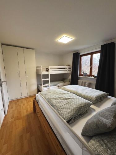 a bedroom with two beds and a window at FeWo Bergruh 922 im Ferienpark Oberallgäu in Missen-Wilhams