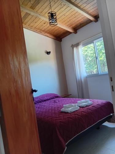 En eller flere senge i et værelse på Cabañas Nazareno