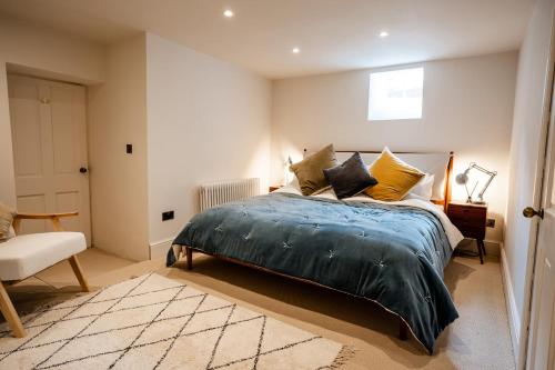 a bedroom with a bed and a chair at BATH Luxury Georgian Flat in Bath