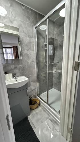 a bathroom with a shower and a sink at Spacious 3 Guests Ensuite Room,Piccadilly Line,Fast Access Central London 1 in London