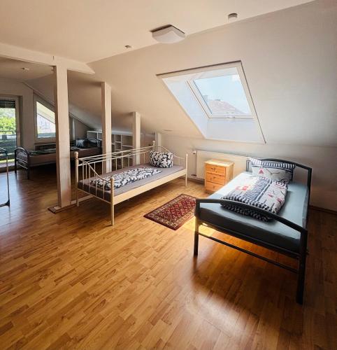 a attic bedroom with two beds and a skylight at GMA Apartment T4 in Kappel-Grafenhausen