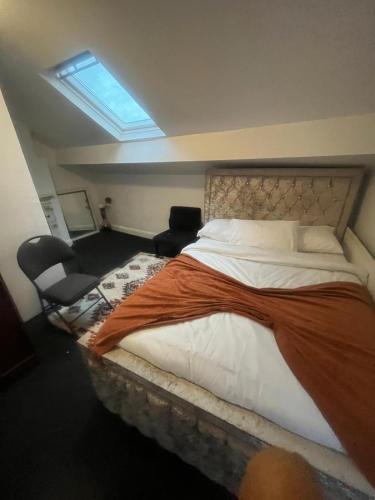 a bedroom with a large bed and a window at Premiership Lodge in Beeston Hill